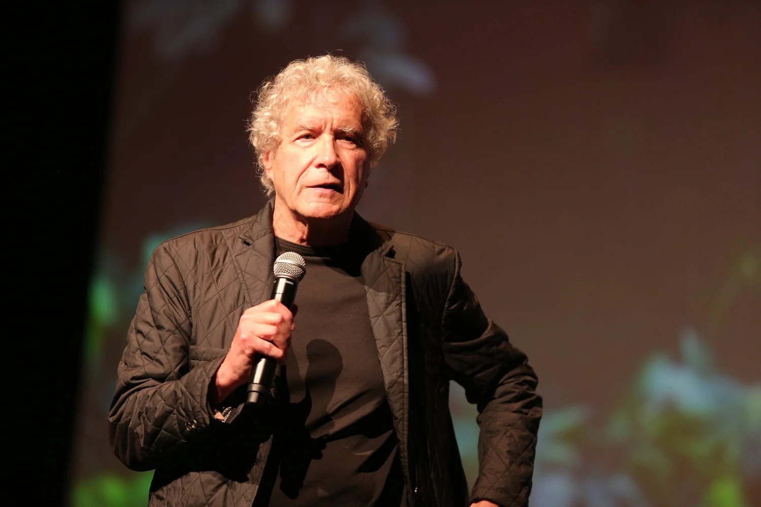 John Perkins speaking on stage